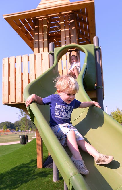 Unity Park held its grand opening on downtown Greenville's west side, Thursday morning, May 19, 2022. Elia Iavarone, 2, makes his way down a slide as he enjoys the park features.