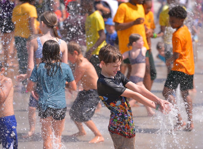 Unity Park held its grand opening on downtown Greenville's west side, Thursday morning, May 19, 2022. The new 60-acre park, nearly two years under construction, completes the "necklace of parks" surrounding downtown. The park "pays homage to the legacies of the neighborhoods surrounding it" and will include affordable housing opportunities. Children enjoy the new water park feature.