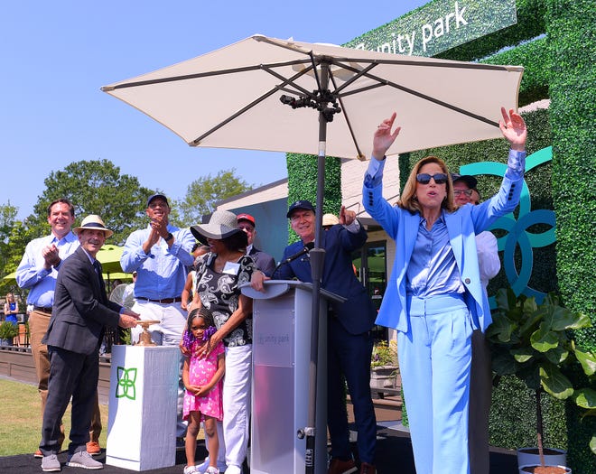 Unity Park held its grand opening on downtown Greenville's west side, Thursday morning, May 19, 2022. Dignitaries start a valve to turn on the water feature for children during the grand opening ceremony.