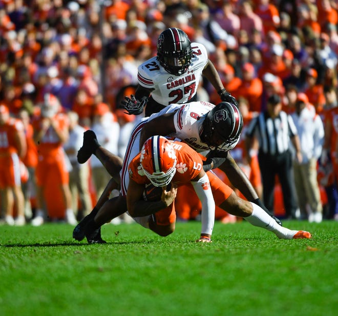 Clemson quarterback D.J. Uiagalelei (5) is tackled by South Carolina edge Gilber Edmond (8) during the game at Memorial Stadium in Clemson, South Carolina Saturday, Nov. 26, 2022.