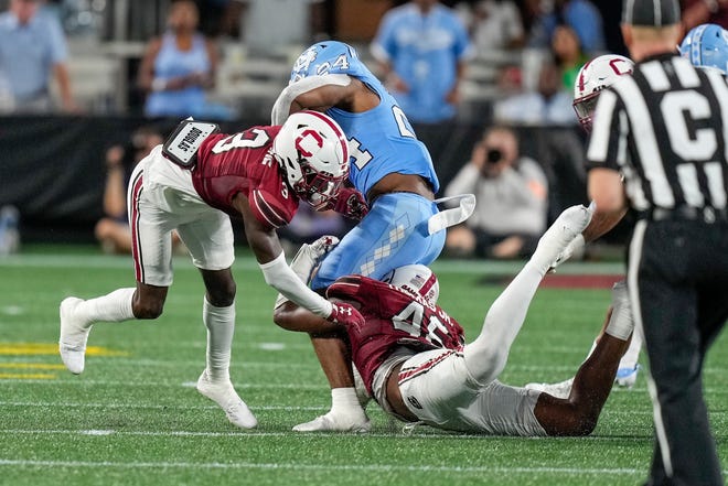 Sep 2, 2023; Charlotte, North Carolina, USA; South Carolina Gamecocks linebacker Mohamed Kaba (32) tackles North Carolina Tar Heels running back British Brooks (24) during the second quarter at Bank of America Stadium. Mandatory Credit: Jim Dedmon-USA TODAY Sports