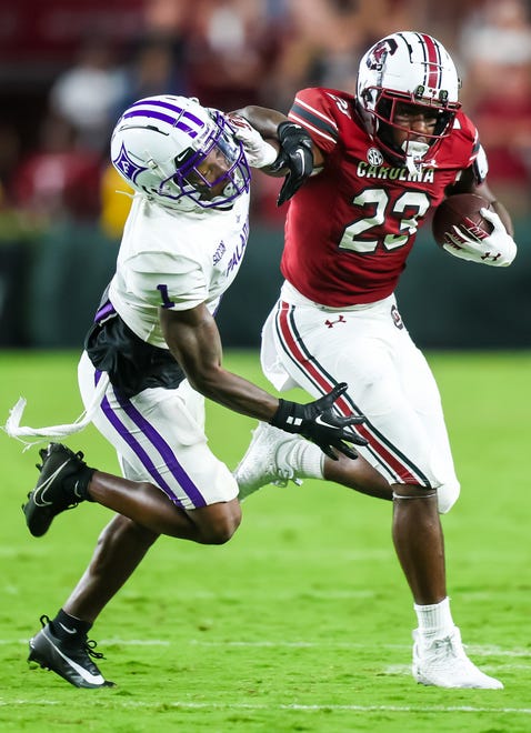 Sep 9, 2023; Columbia, South Carolina, USA; South Carolina Gamecocks running back Djay Braswell (23) attempts to get around Furman Paladins cornerback Travis Blackshear (1) during the second half at Williams-Brice Stadium. Mandatory Credit: Jeff Blake-USA TODAY Sports