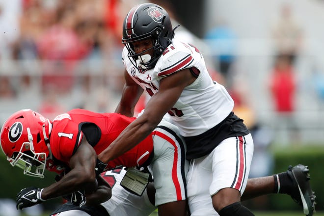 Georgia wide receiver Marcus Rosemy-Jacksaint (1) is stopped by South Carolina wide receiver Tyshawn Russell (21) during the first half of a NCAA college football game in Athens, Ga., on Saturday, Sept. 16, 2023.