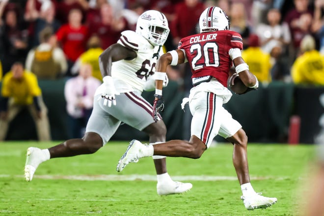 Sep 23, 2023; Columbia, South Carolina, USA; South Carolina Gamecocks defensive back Judge Collier (20) returns a fumble as Mississippi State Bulldogs offensive lineman Nick Jones (66) pursues in the second half at Williams-Brice Stadium. Mandatory Credit: Jeff Blake-USA TODAY Sports