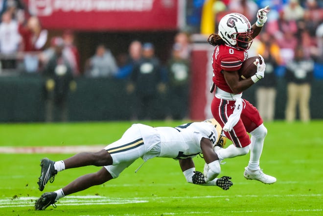 Nov 11, 2023; Columbia, South Carolina, USA; South Carolina Gamecocks running back Juju McDowell (0) runs around Vanderbilt Commodores linebacker Jeffrey Ugochukwu (12) in the first quarter at Williams-Brice Stadium. Mandatory Credit: Jeff Blake-USA TODAY Sports