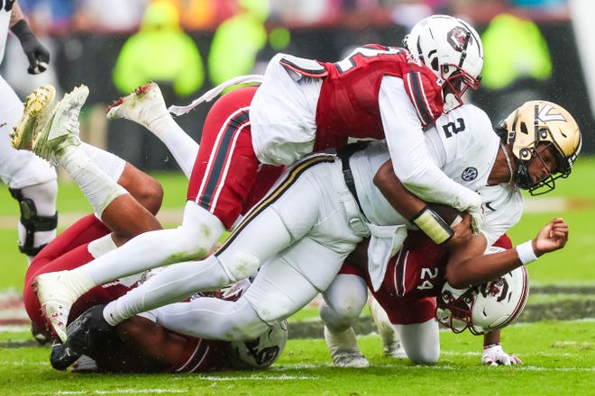 Nov 11, 2023; Columbia, South Carolina, USA; Vanderbilt Commodores quarterback Walter Taylor (2) is tackled by South Carolina Gamecocks linebacker Bam Martin-Scott (22) in the second quarter at Williams-Brice Stadium. Mandatory Credit: Jeff Blake-USA TODAY Sports