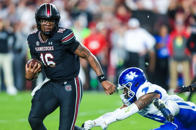 Nov 18, 2023; Columbia, South Carolina, USA; South Carolina Gamecocks quarterback LaNorris Sellers (16) rushes past Kentucky Wildcats defensive back Zion Childress (11) in the first quarter at Williams-Brice Stadium. Mandatory Credit: Jeff Blake-USA TODAY Sports Kentucky