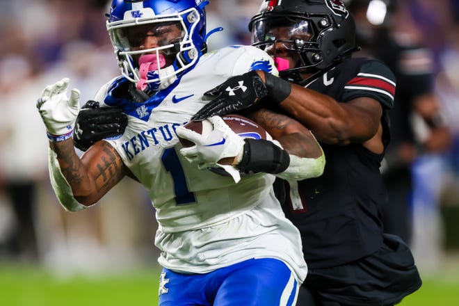 Nov 18, 2023; Columbia, South Carolina, USA; Kentucky Wildcats running back Ray Davis (1) drags South Carolina Gamecocks defensive back DQ Smith (1) over the goal line for a touchdown in the second half at Williams-Brice Stadium. Mandatory Credit: Jeff Blake-USA TODAY Sports Kentucky