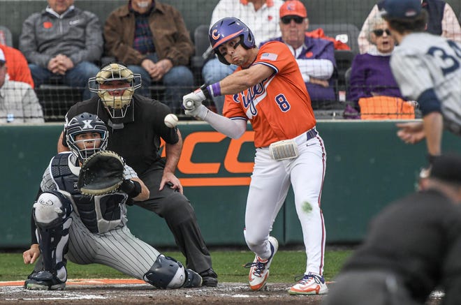 Clemson senior Blake Wright(8) hits off of Xavier University junior Luke Hoskins (34) during the bottom of the second inning at Doug Kingsmore Stadium in Clemson Friday, February 16, 2024.