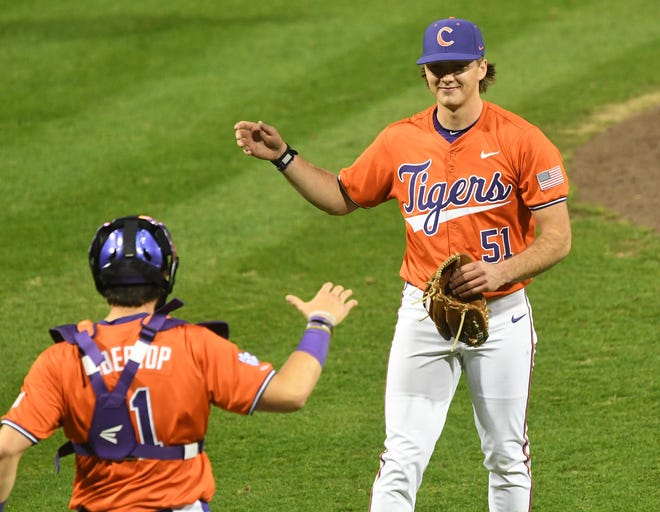 Clemson junior relief pitcher Rocco Reid (51) is congratulated by catcher Jimmy Obertop after the Tigers 14-3 win over Xavier University in the season opener at Doug Kingsmore Stadium in Clemson Friday, February 16, 2024.