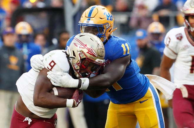 Nov 4, 2023; Pittsburgh, Pennsylvania, USA; Pittsburgh Panthers linebacker Bangally Kamara (11) tackles Florida State Seminoles running back Lawrance Toafili (9) in the backfield during the second quarter at Acrisure Stadium. Mandatory Credit: Charles LeClaire-USA TODAY Sports