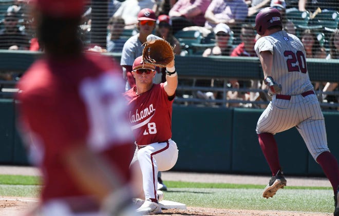 Mar 30, 2024; Tuscaloosa, Alabama, USA; Alabama first baseman Will Hodo (18) stretches out to receive a throw from Gage Miller to nab South Carolina batter Ethan Petry at Sewell-Thomas Stadium in the final game of the weekend series. South Carolina held on for a 9-8 victory.