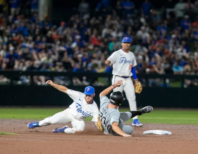 Gators infielder Cade Kurland (4) tags out Gamecocks utility Ethan Petry (20) in the top of the fifth inning against South Carolina in Game 1 of NCAA Super Regionals, Friday, June 9, 2023, at Condron Family Ballpark in Gainesville, Florida.Florida beat the Gamecocks 5-4. [Cyndi Chambers/ Gainesville Sun] 2023