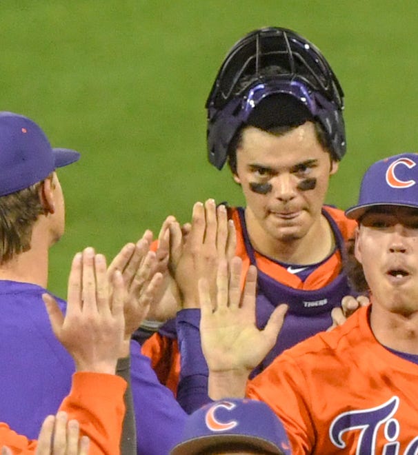 Clemson catcher Jimmy Obertop high-fives teammates after beating Xavier during practice at Doug Kingsmore Stadium in Clemson, S.C. Friday, February 16, 2024.