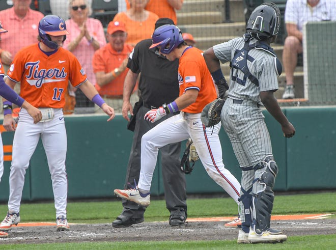 Clemson senior Blake Wright (8) stomps on home plate after hitting a home run against Georgia Tech during the bottom of the third inning at Doug Kingsmore Stadium in Clemson Friday, May 3, 2024.