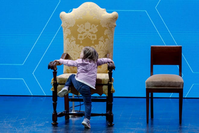 May 10, 2024: A child climbs Pope Francis' seat at the "The General State of the Birth Rate" conference on Italy's sliding birthrate, in Rome.