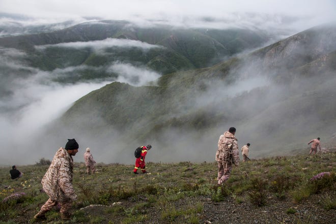 May 20, 2024: Rescue team members search an area near the crash site of a helicopter carrying Iranian President Ebrahim Raisi in Varzaghan, in northwestern Iran. Iranian President Ebrahim Raisi was declared dead on May 20 after rescue teams found his crashed helicopter in a fog-shrouded western mountain region, sparking mourning in the Islamic republic.