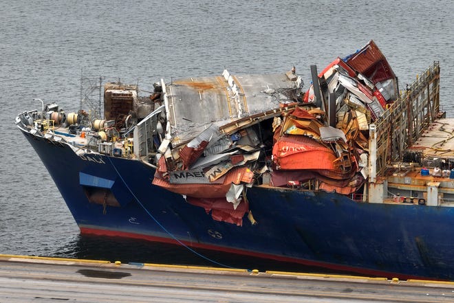 May 20, 2024: In this aerial view, portions of the Francis Scott Key Bridge remain lapped over the bow of the damaged container ship Dali after it was docked at the Seagirt Marine Terminal in Baltimore, Maryland. On March 26th, the Dali crashed into the bridge, causing it to collapse, killing six construction workers, and closing the Patapsco River and the Port of Baltimore for weeks.