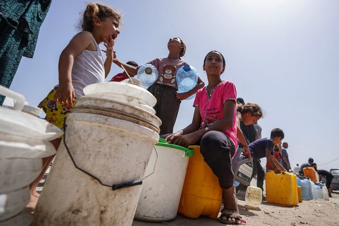 May 21, 2024: Displaced Palestinians queue for water at a camp west of Deir al-Balah in the Gaza Strip amid the ongoing conflict between Israel and the Palestinian militant group Hamas.