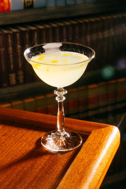 The Golden Toad is Beefeater gin combined with ginger and lemon with a house-made basil oil artistically placed to become floating chartreuse lily pads.