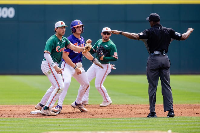 May 23, 2024; Charlotte, NC, USA; Clemson Tigers utility Jimmy Obertop (11) slides safely into second against Miami (FL) Hurricanes infielder Antonio Jimenez (13) for a stolen base during the ACC Baseball Tournament at Truist Field. Mandatory Credit: Scott Kinser-USA TODAY Sports