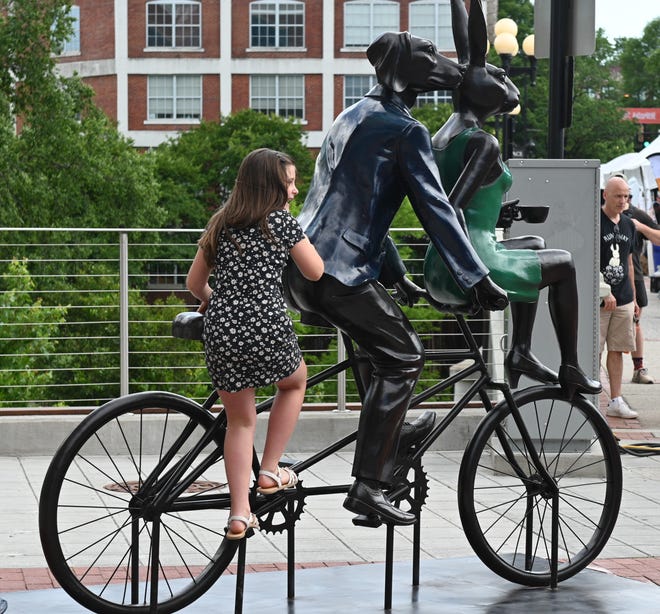 Trying out the interactive sculpture “Tandem Lovers,” created by Australian artists Gillie and Marc Schattner, was presented to the City of Greenville as a gift from the Artisphere festival. The downtown arts extravaganza is celebrating its 20th anniversary in 2024. The work, the fifth that the festival has given to the city, is located on Main Street near Camperdown Plaza.