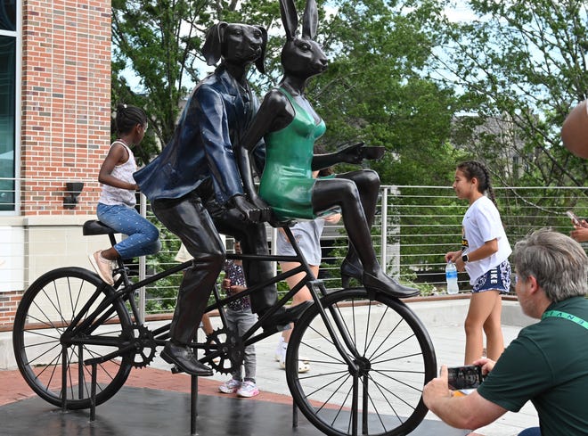 The unveiling of the sculpture “Tandem Lovers,” created by Australian artists Gillie and Marc Schattner. The work was presented to the City of Greenville as a gift from the Artisphere festival. The downtown arts extravaganza is celebrating its 20th anniversary in 2024. This is the fifth work that the festival has given to the city.