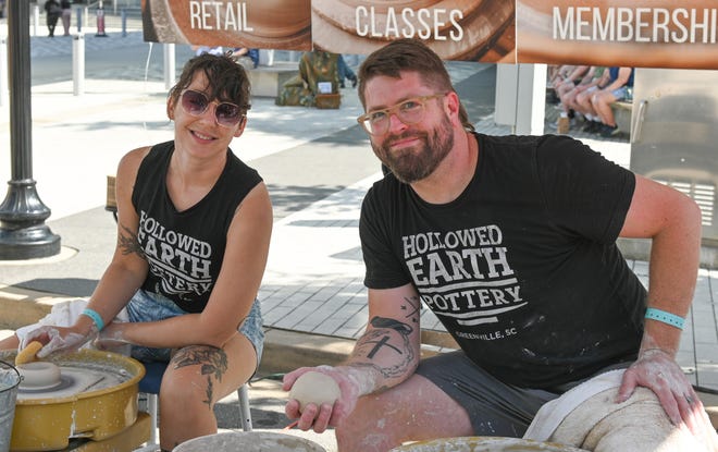 Artists Mark Batory and Kat McGuire create pottery during the unveiling of the sculpture “Tandem Lovers,” created by Australian artists Gillie and Marc Schattner, was presented to the City of Greenville as a gift from the Artisphere festival. The downtown arts extravaganza is celebrating its 20th anniversary in 2024. This is the fifth work that the festival has given to the city.