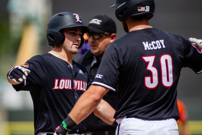 May 24, 2024; Charlotte, NC, USA; Louisville Cardinals catcher Luke Napleton (35) hugs infielder Ryan McCoy (30) after a home run in the second inning against the Clemson Tigers during the ACC Baseball Tournament at Truist Field. Mandatory Credit: Scott Kinser-USA TODAY Sports