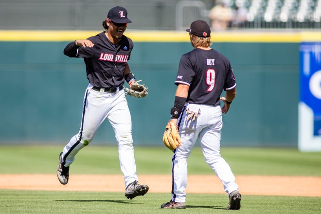 May 24, 2024; Charlotte, NC, USA; Louisville Cardinals outfielder JT Benson (13) celebrates with infielder Dylan Hoy (9) after getting the final out of the third inning against the Clemson Tigers during the ACC Baseball Tournament at Truist Field. Mandatory Credit: Scott Kinser-USA TODAY Sports