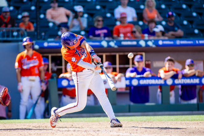 May 24, 2024; Charlotte, NC, USA; Clemson Tigers infielder Blake Wright (8) connects in the sixth inning against the Louisville Cardinals during the ACC Baseball Tournament at Truist Field. Mandatory Credit: Scott Kinser-USA TODAY Sports