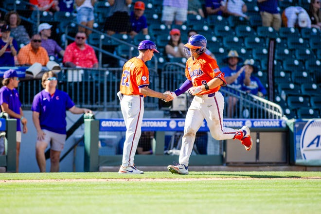 May 24, 2024; Charlotte, NC, USA; Clemson Tigers catcher Jacob Jarrell (9) celebrates with assistant head coach Nick Schnabel after a home run in the sixth inning against the Louisville Cardinals during the ACC Baseball Tournament at Truist Field. Mandatory Credit: Scott Kinser-USA TODAY Sports