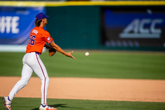 May 24, 2024; Charlotte, NC, USA; Clemson Tigers pitcher Austin Gordon (56) tosses the ball to first for an out in the ninth inning against the Louisville Cardinals during the ACC Baseball Tournament at Truist Field. Mandatory Credit: Scott Kinser-USA TODAY Sports