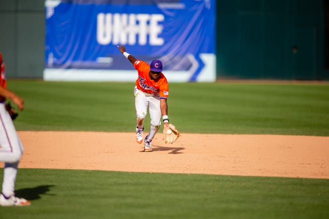 May 24, 2024; Charlotte, NC, USA; Clemson Tigers infielder Jarren Purify (23) fields the ball in the ninth inning against the Louisville Cardinals during the ACC Baseball Tournament at Truist Field. Mandatory Credit: Scott Kinser-USA TODAY Sports