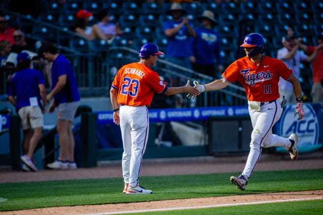 May 24, 2024; Charlotte, NC, USA; Clemson Tigers utility Jimmy Obertop (11) celebrates a three run homer with \assistant head coach Nick Schnabel in the seventh inning against the Louisville Cardinals during the ACC Baseball Tournament at Truist Field. Mandatory Credit: Scott Kinser-USA TODAY Sports