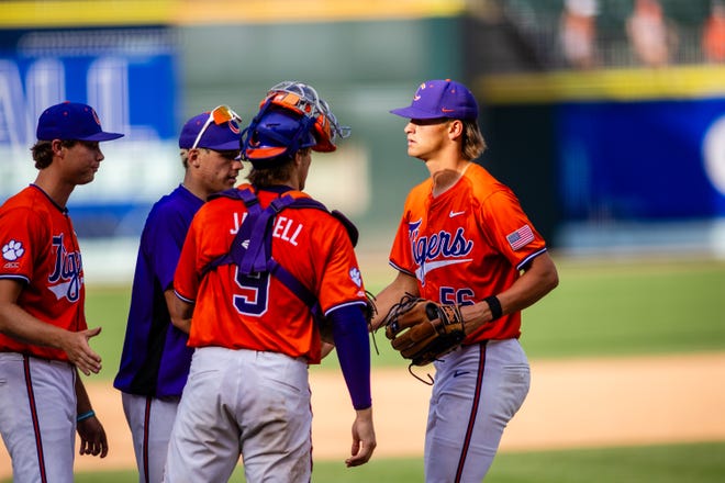 May 24, 2024; Charlotte, NC, USA; Clemson Tigers pitcher Austin Gordon (56) is congratulated after closing out the ninth inning against the Louisville Cardinals during the ACC Baseball Tournament at Truist Field. Mandatory Credit: Scott Kinser-USA TODAY Sports