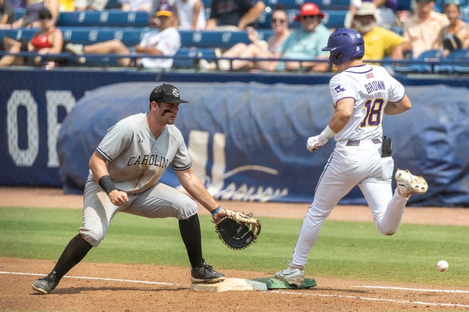 May 25, 2024; Hoover, AL, USA; LSU Tigers outfielder Jake Brown (18) reaches first safely on the green bag as South Carolina Gamecocks utility Ethan Petry (20) covers the white bag during the SEC Baseball Tournament at Hoover Metropolitan Stadium. Mandatory Credit: Vasha Hunt-USA TODAY Sports