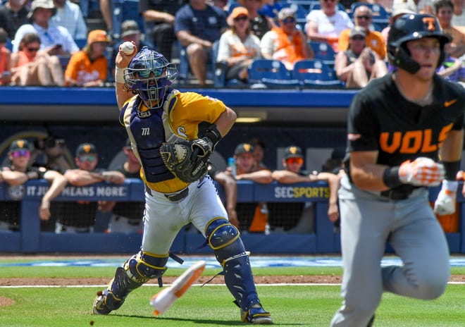 May 26 2024; Hoover, AL, USA; LSU catcher Alex Milazzo (7) throws to first on a third strike to get a Tennessee batter at the Hoover Met during the championship game of the SEC Tournament.