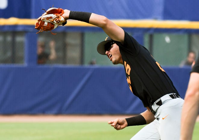 May 26 2024; Hoover, AL, USA; Tennessee shortstop Dean Curley (23) snags a fly ball in shallow left field against LSU at the Hoover Met during the championship game of the SEC Tournament.