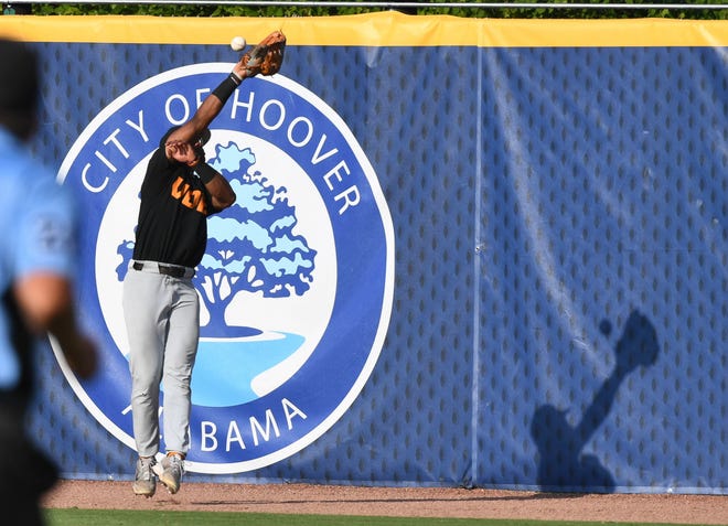 May 26 2024; Hoover, AL, USA; A ball hit by an LSU batter in the 9th evades a leaping try by Tennessee outfielder Kavares Tears (21) and goes for a double at the Hoover Met during the championship game of the SEC Tournament. Tennessee held on to win 4-3.