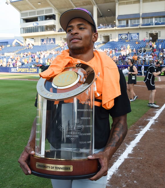 May 26 2024; Hoover, AL, USA; Tennessee second baseman Christian Moore (1) carries the championship trophy at the Hoover Met after the championship game of the SEC Tournament. Tennessee held on to win 4-3.