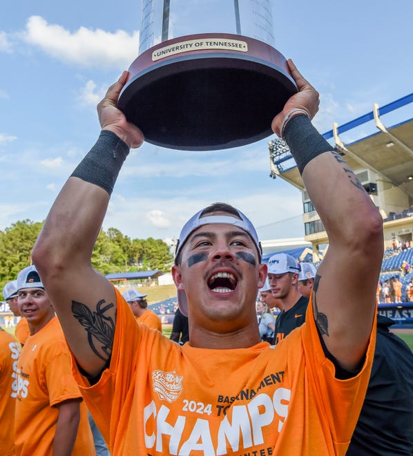 May 26 2024; Hoover, AL, USA; Tennessee outfielder Hunter Ensley (9) lifts the trophy in celebration at the Hoover Met following the championship game of the SEC Tournament. Tennessee held on to win 4-3.