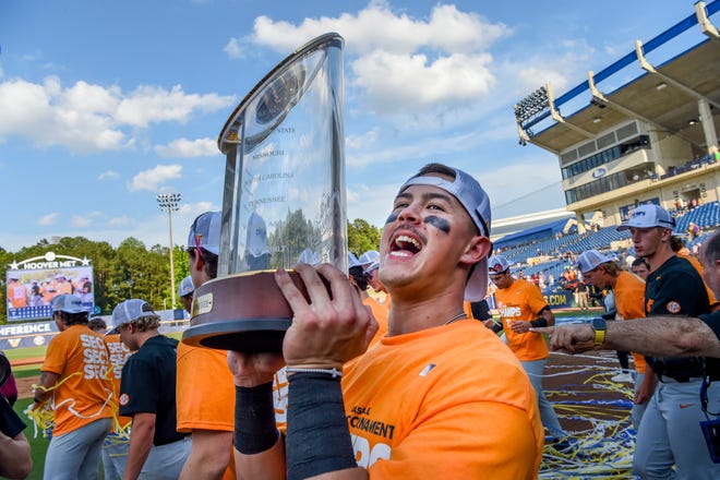 May 26 2024; Hoover, AL, USA; Tennessee outfielder Hunter Ensley (9) lifts the trophy in celebration at the Hoover Met following the championship game of the SEC Tournament. Tennessee held on to win 4-3.