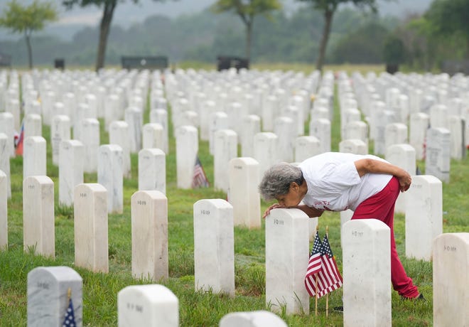 May 27, 2024 : Orie Sanchez, of Copperas Cove, visits the grave of her husband, Army Vietnam War veteran Faustino Sanchez who died of COVID in 2020, at the Central Texas State Veterans Cemetery in Killeen on Memorial Day.