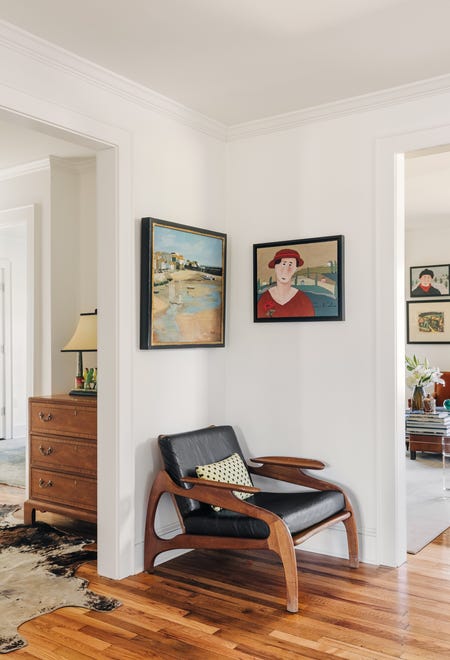 A doorway is flanked by matching mid-century modern chairs.