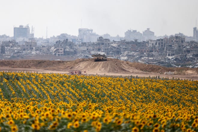 An Israeli army tank deploys near a sunflower field in Israel's southern border with the Gaza Strip on May 28, 2024, amid the ongoing conflict between Israel and the militant group Hamas.