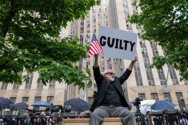 People celebrate after former President Donald Trump was found guilty on all counts at Manhattan Criminal Court on May 30, 2024 in New York City. The former president was found guilty on all 34 felony counts of falsifying business records in the first of his criminal cases to go to trial.