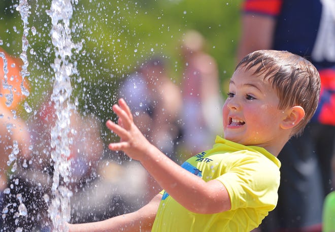 Unity Park held its grand opening on downtown Greenville's west side, Thursday morning, May 19, 2022. The new 60-acre park, nearly two years under construction, completes the "necklace of parks" surrounding downtown. The park "pays homage to the legacies of the neighborhoods surrounding it" and will include affordable housing opportunities. Children enjoy the new water park feature.