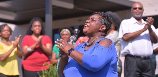 Unity Park held its grand opening on downtown Greenville's west side, Thursday morning, May 19, 2022. Members of the West End Community Choir sing during the grand opening ceremony.