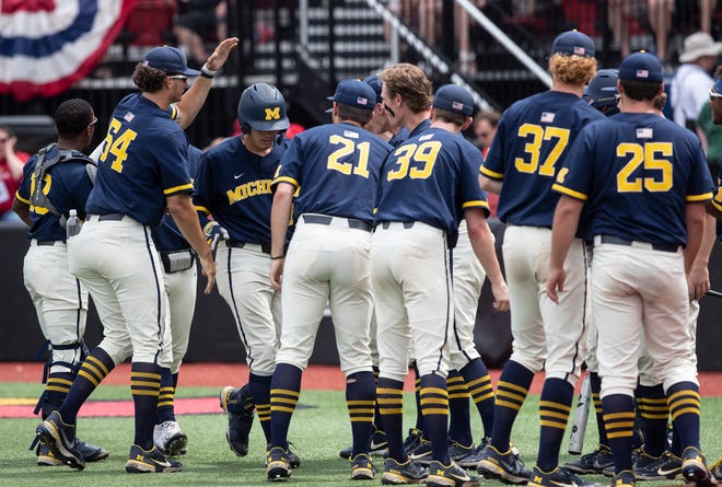 Michigan's Jimmy Obertop is congratulated by teammates after hitting a three run homer against University of Louisville in the championship game of the NCAA Louisville regional baseball tournament. June 6, 2022